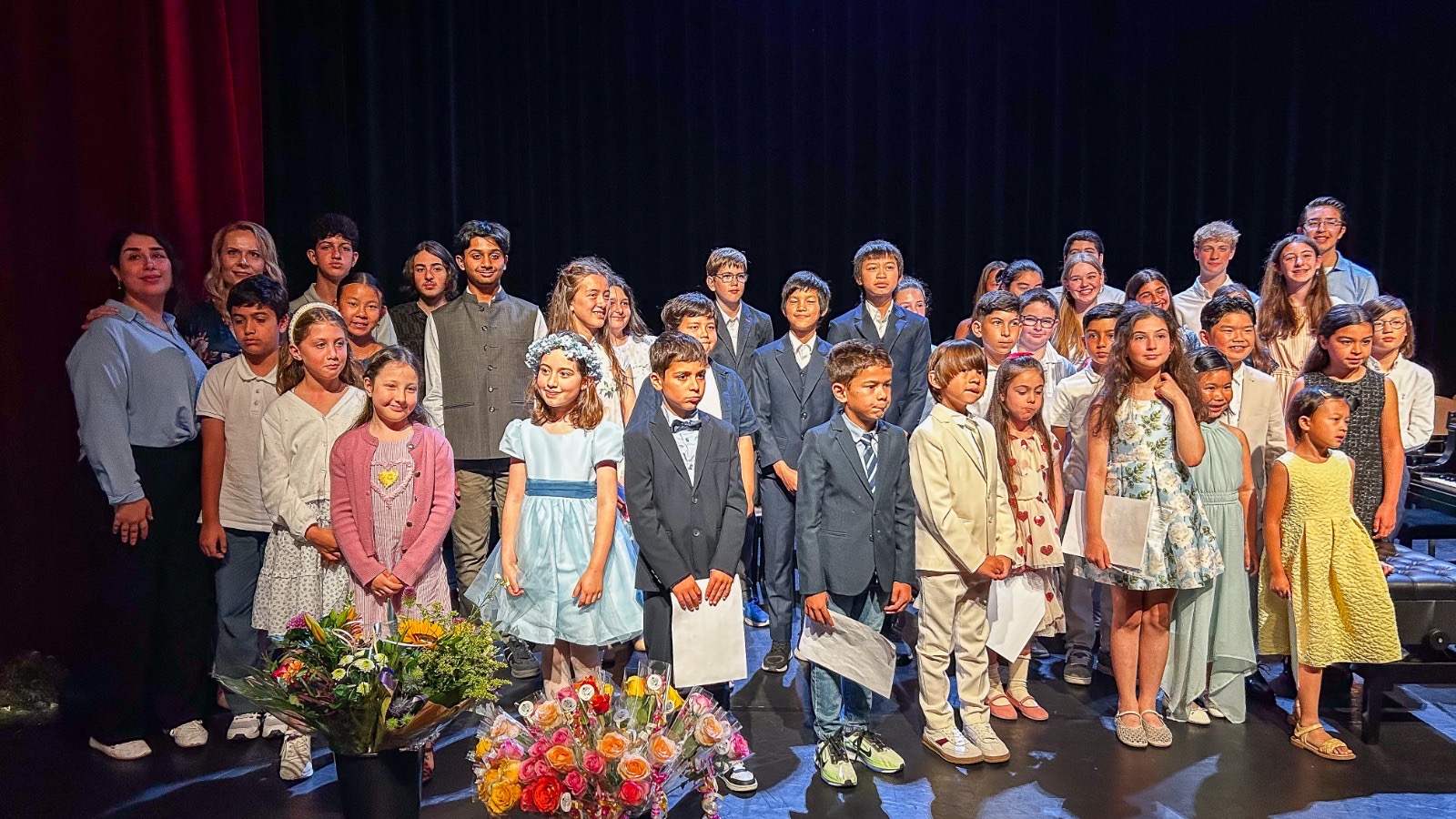 Group of Keser Piano Academy students and teachers on stage