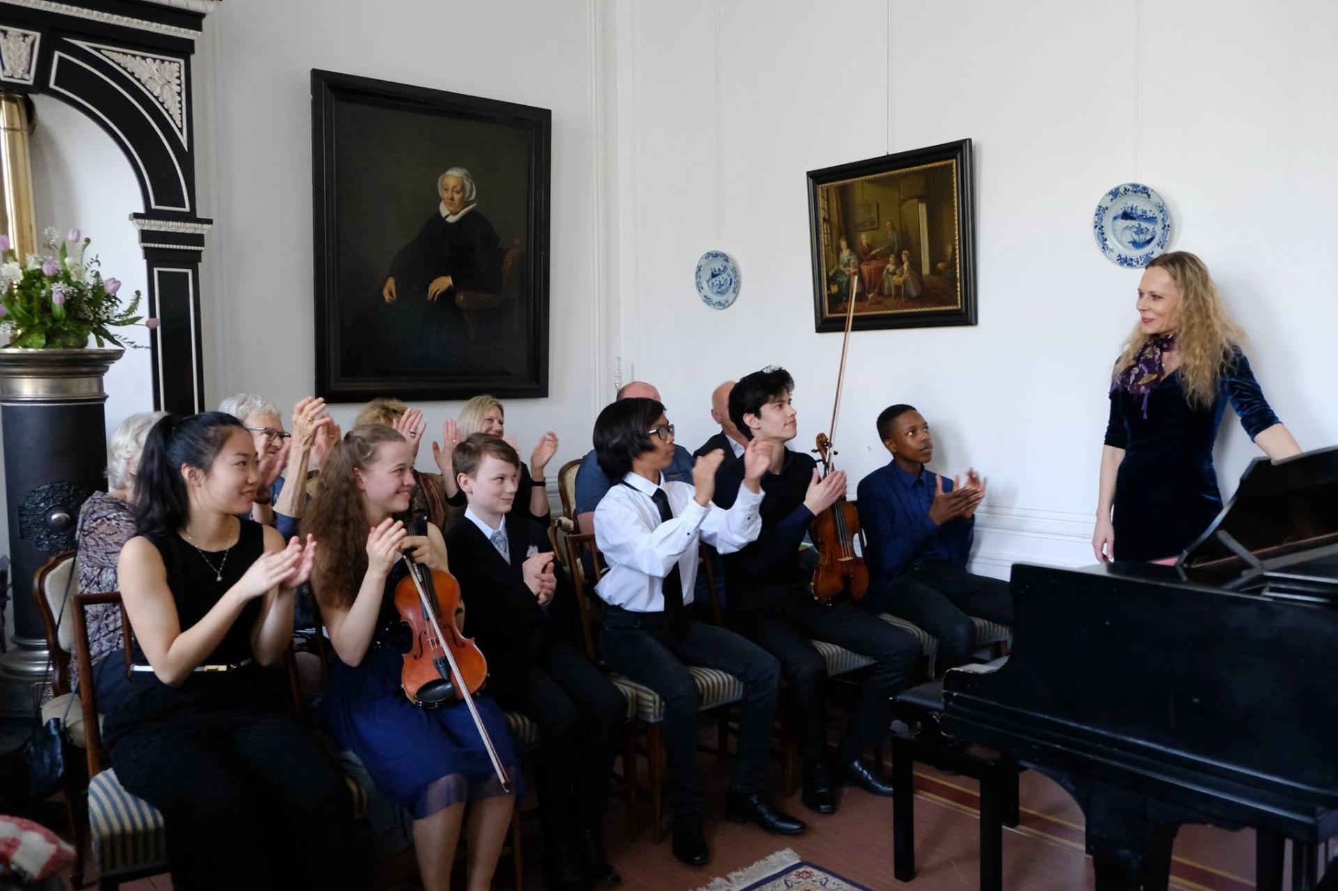 Students applauding after a recital